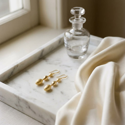 14K Yellow Gold Elongated Drop Earrings, on marble vanity tray with silk