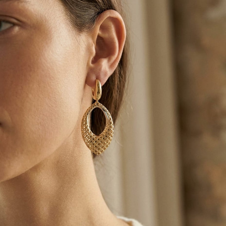 14K Two-Tone Gold Twisted Oval Drop Earrings, worn close-up portrait