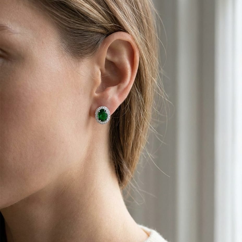 Emerald Oval Stud Earrings in 14K White Gold, worn close-up portrait