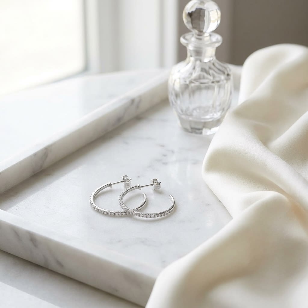 Diamond Pave J-hoop Earrings With Push Backs in 14K White Gold, on marble vanity tray with silk