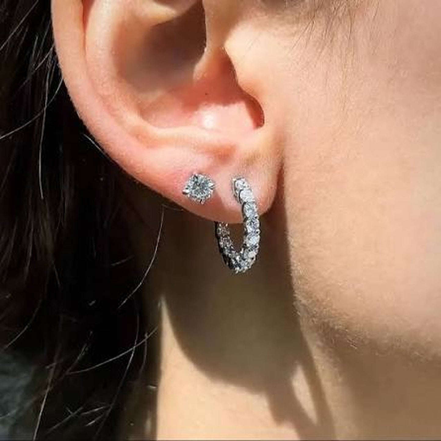 Lab grown diamond inside-out hoops shown on ear in 14kt yellow gold pair