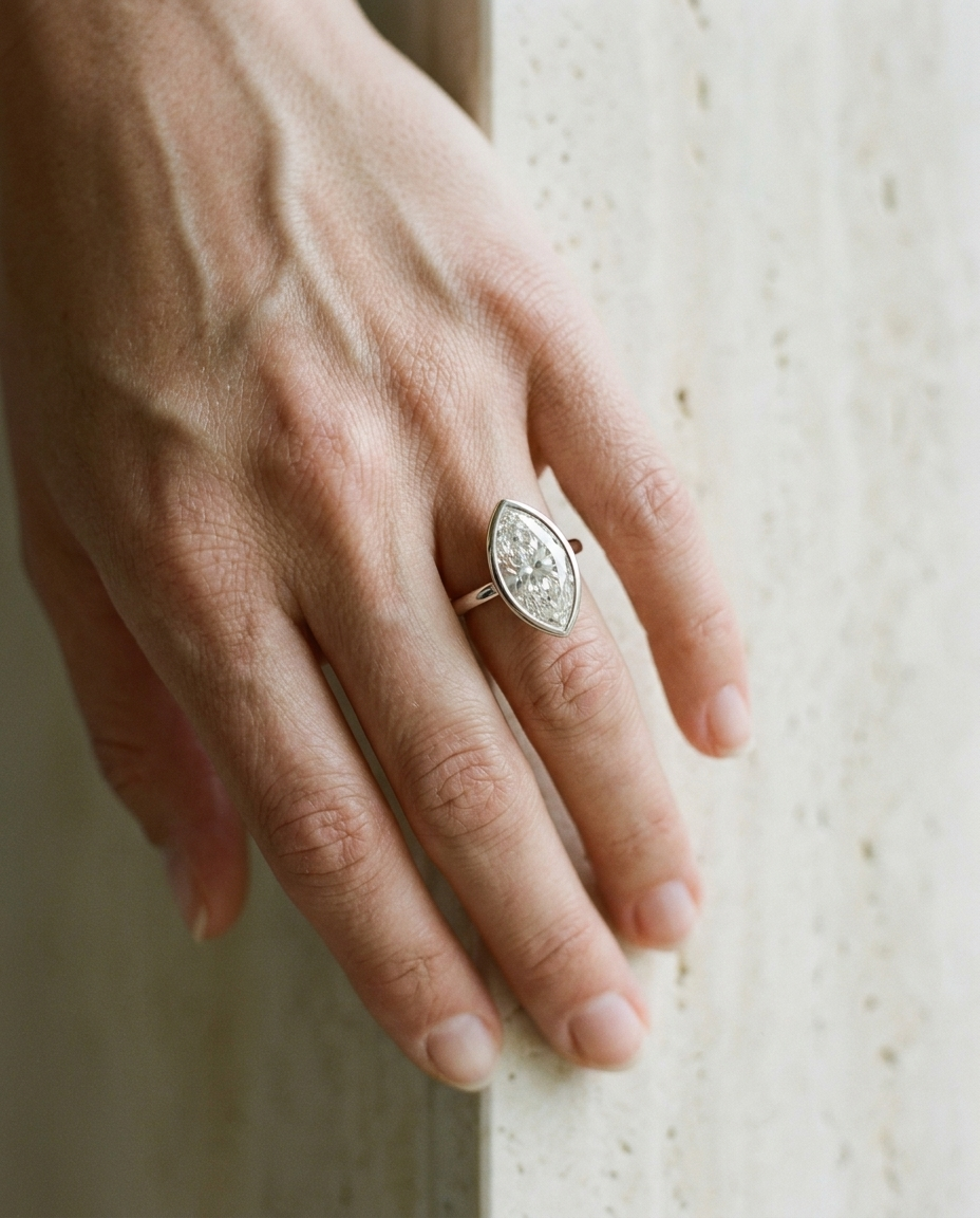 The Agnes Select bezel solitaire marquise engagement ring in platinum — on hand — RockHer
