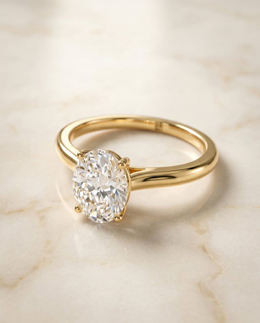 The Gladys Solitaire Engagement Ring Setting for Oval Diamonds in 18K Yellow Gold