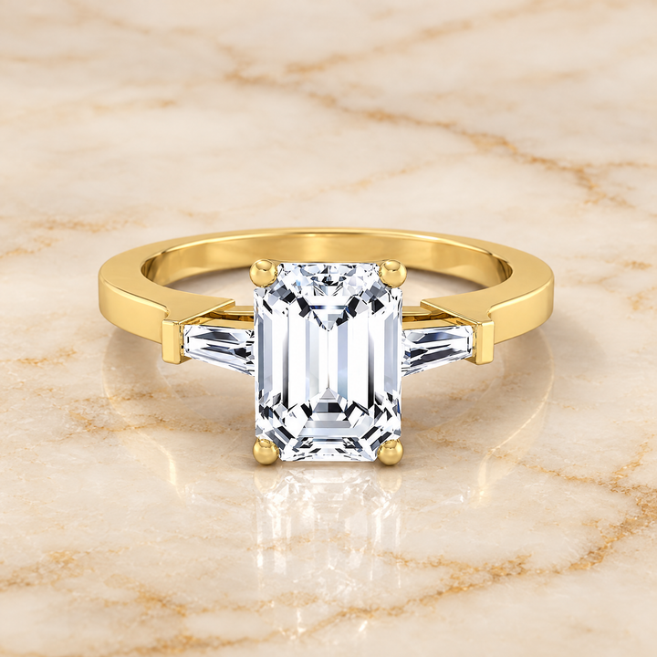 The June Three Stone Emerald Cut Engagement Ring Setting in 18K Yellow Gold