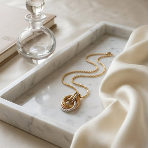 14K Tri-Color Gold Interlocking Teardrop Pendant Necklace, 18 Inch, on marble vanity tray with silk
