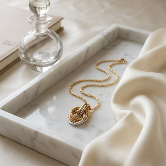 14K Tri-Color Gold Interlocking Teardrop Pendant Necklace, 18 Inch, on marble vanity tray with silk