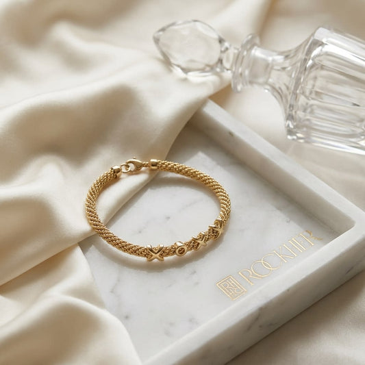 14K Yellow Gold Textured XOX Link Bracelet, 7.5 Inch, on marble vanity tray with silk