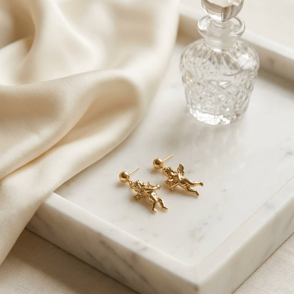 14K Yellow Gold Angel Drop Earrings, on marble vanity tray with silk