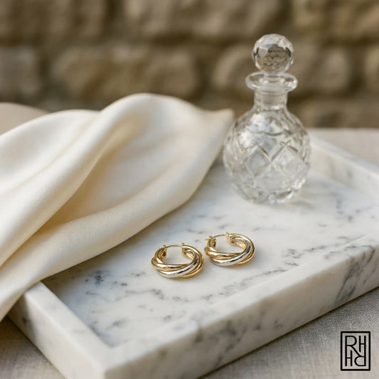 14K Two-Tone Gold Sculpted Hoop Earrings, on marble vanity tray with silk