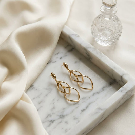 14K Yellow Gold Twisted Open-Link Drop Earrings, on marble vanity tray with silk