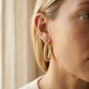 14K Yellow Gold Beaded Oval Hoop Earrings, worn close-up portrait