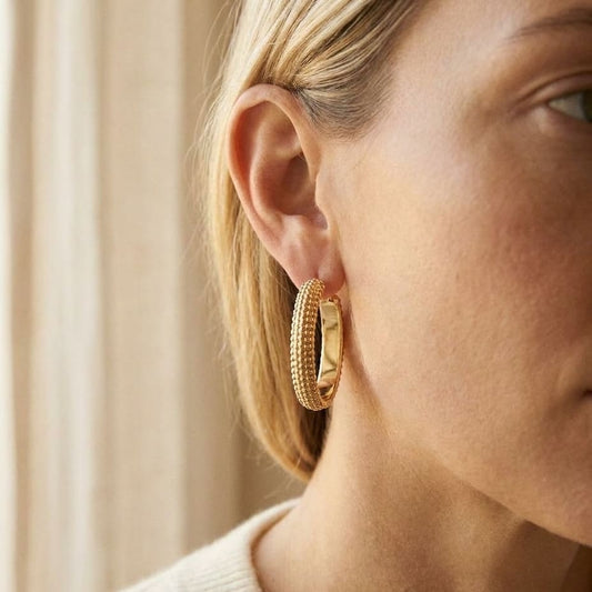 14K Yellow Gold Beaded Oval Hoop Earrings, worn close-up portrait