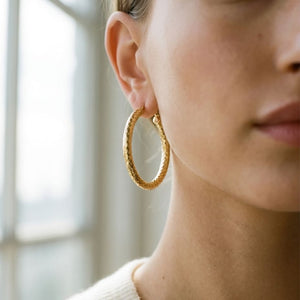 14K Yellow Gold Textured Hoop Earrings, worn close-up portrait