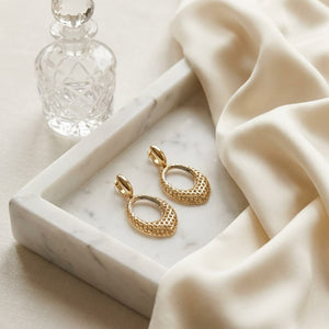 14K Two-Tone Gold Twisted Oval Drop Earrings, on marble vanity tray with silk