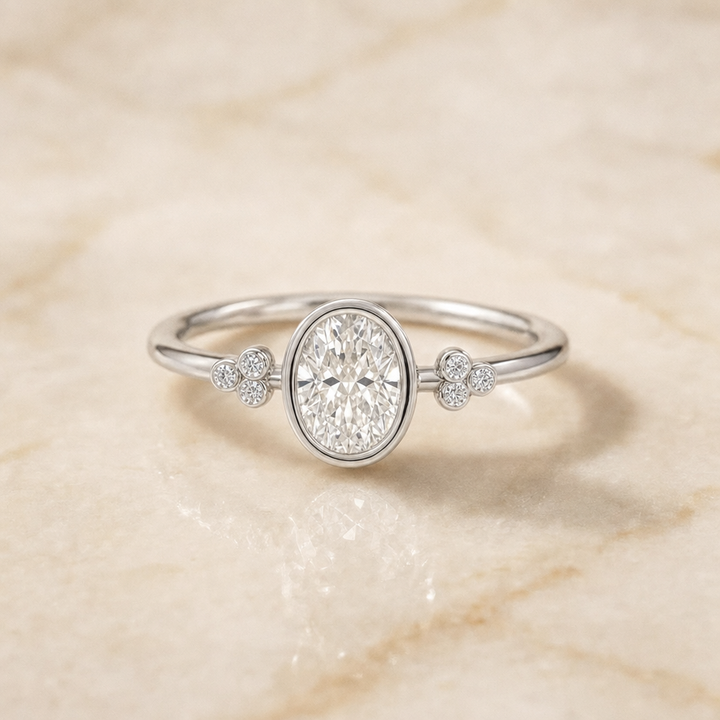 The Selena Clover Bezel Accent Solitaire Oval Engagement Ring Setting in 18K White Gold