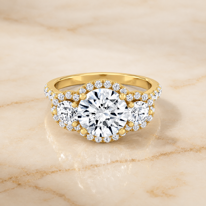 The Andrea Three Stone Halo Round Engagement Ring Setting in 18K Yellow Gold
