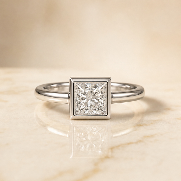 The Agnes Bezel Solitaire In Princess Cut Engagement Ring Setting in 18K White Gold