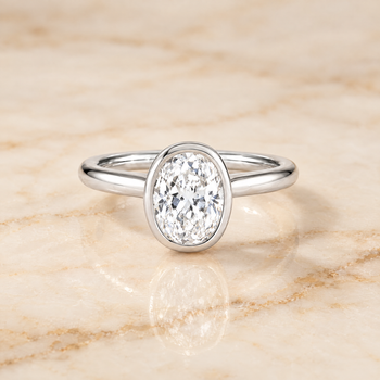 The Duran Simple Bezel Solitaire Oval Engagement Ring Setting in 18K White Gold