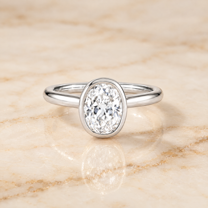 The Duran Simple Bezel Solitaire Oval Engagement Ring Setting in Platinum