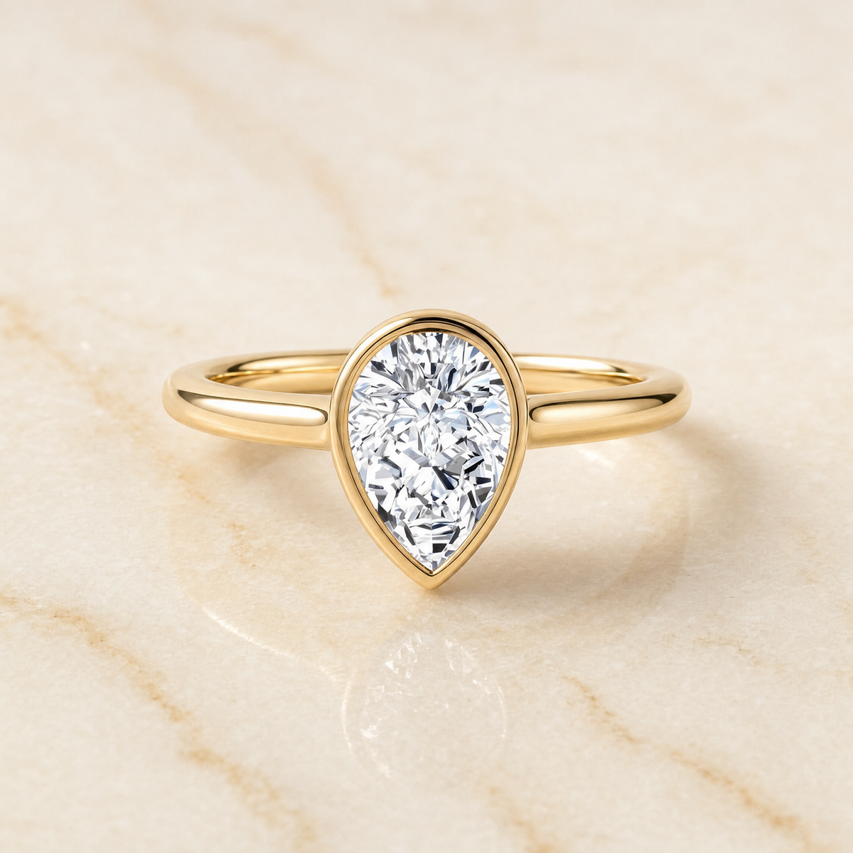 The Duran Simple Bezel Solitaire Pear Engagement Ring Setting in 18K Yellow Gold