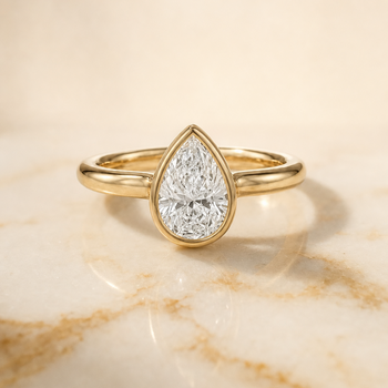 The Agnes Bezel Solitaire In Pear Engagement Ring Setting in 18K Yellow Gold
