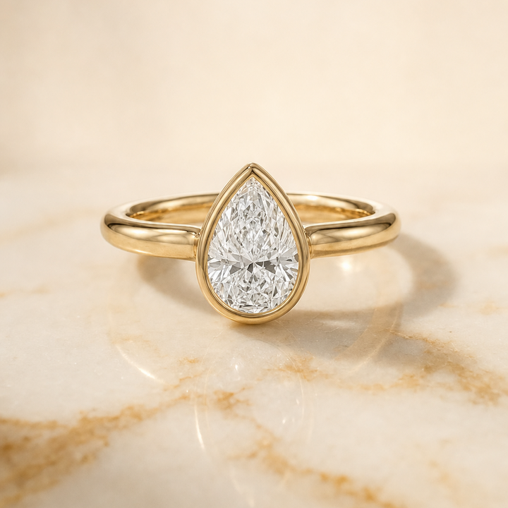 The Agnes Bezel Solitaire In Pear Engagement Ring Setting in 18K Yellow Gold