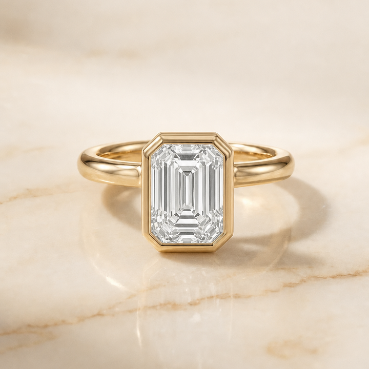 The Agnes Bezel Solitaire In Emerald Cut Engagement Ring Setting in 18K Yellow Gold