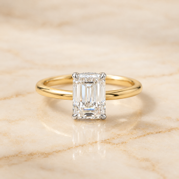 The Cyndi Curved Hidden Halo Solitaire Emerald Cut Engagement Ring Setting in 18K Yellow Gold