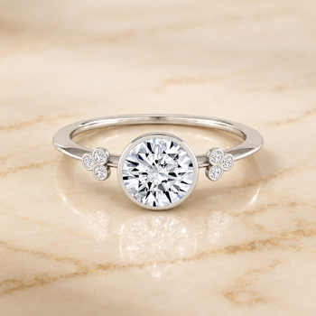 The Selena Clover Bezel Accent Solitaire Round Engagement Ring Setting in 18K White Gold