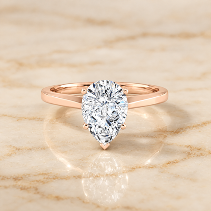 The Elena Timeless Graduated Beveled Shank Solitaire Pear Engagement Ring Setting in 14K Rose Gold