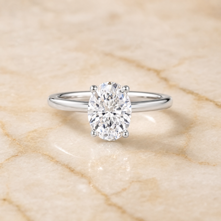 The Lana Secret Halo Adorned Prong Solitaire Oval Engagement Ring Setting in 18K White Gold