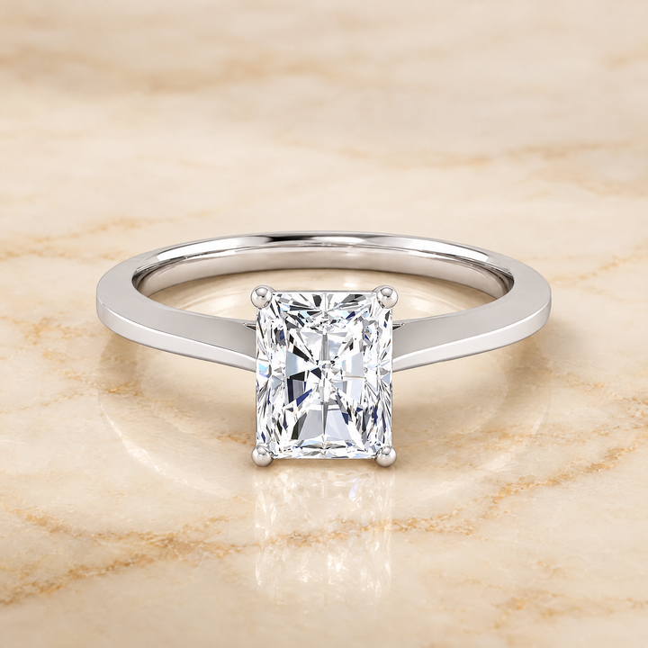 The Elena Timeless Graduated Beveled Shank Solitaire Radiant Cut Engagement Ring Setting in Platinum