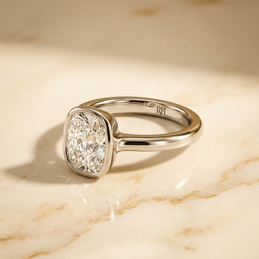 The Agnes bezel solitaire cushion engagement ring setting in platinum — alt-angle hero — RockHer