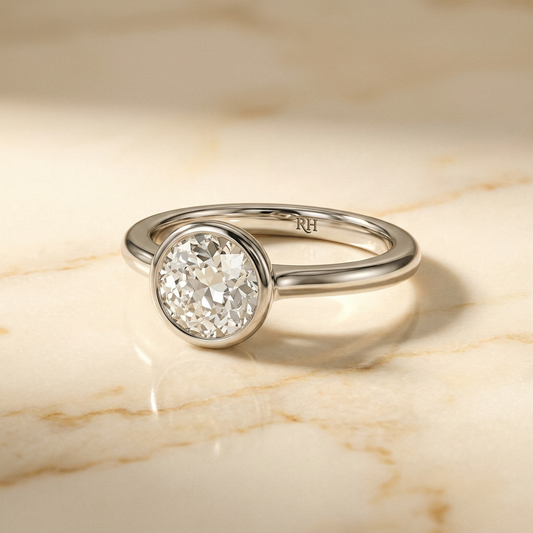 The Agnes bezel solitaire old european cut engagement ring setting in 18k white gold — alt-angle hero — RockHer