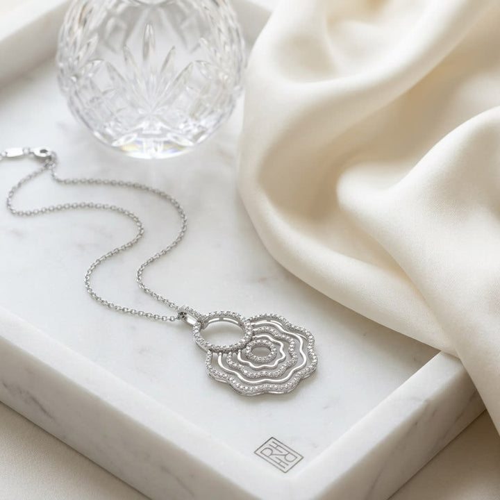 Natural Diamond Round Brilliant Pendant in 18K White Gold, on marble vanity tray with silk