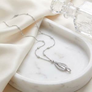 Natural Diamond Round Brilliant Pendant in 18K White Gold, 5 ct. t.w., on marble vanity tray with silk
