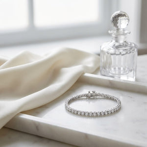 Diamond 4-prong Tennis Bracelet in 18K White Gold, on marble vanity tray with silk