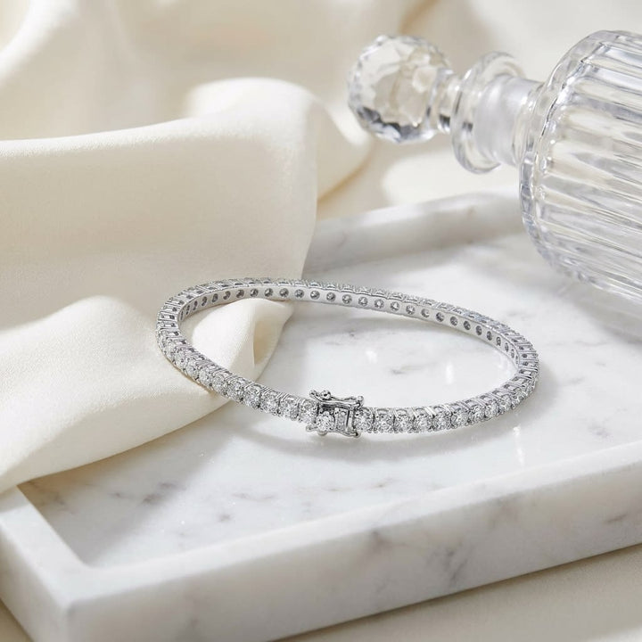 Diamond Bangle Bracelet in 18K White Gold, on marble vanity tray with silk