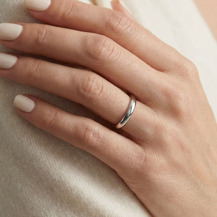 3mm Slightly Domed Traditional Oval Wedding Band in 18K White Gold, worn on hand, close-up