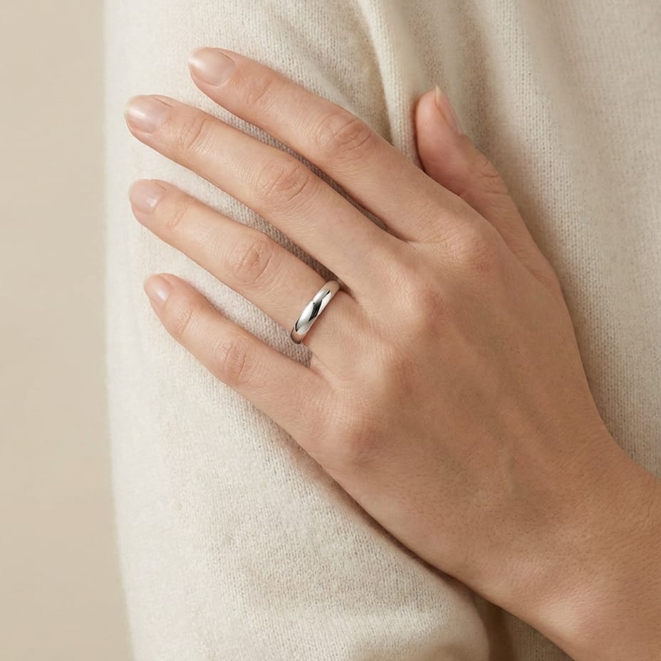 4mm Slightly Domed Traditional Oval Wedding Band in 18K White Gold, worn on hand, full view