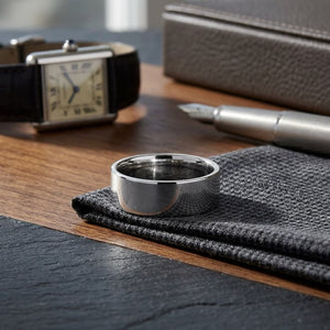 8mm Flat Comfort-Fit Wedding Band in 18K White Gold, on walnut surface with pocket square