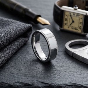 8mm Flat Milgrain Comfort-Fit Wedding Band in 18K White Gold, on walnut surface with pocket square