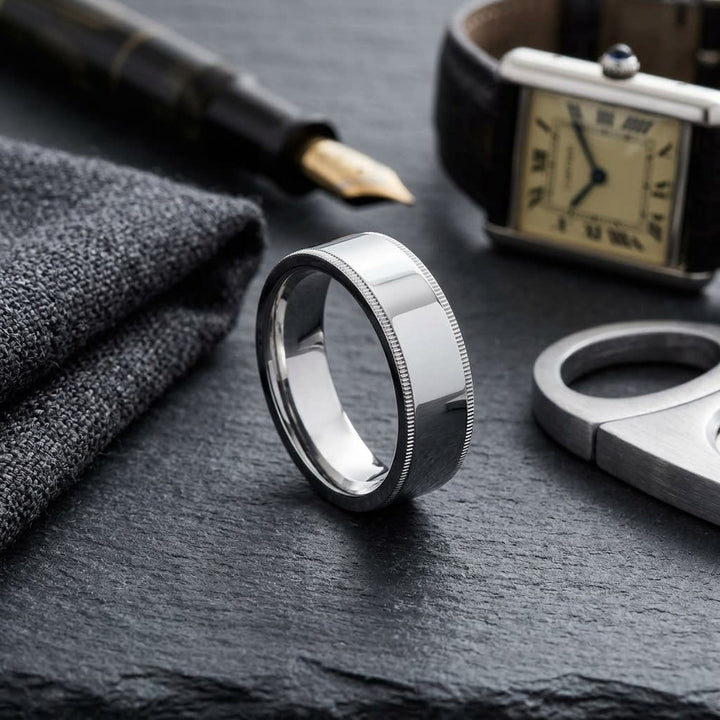 8mm Flat Milgrain Comfort-Fit Wedding Band in 18K White Gold, on walnut surface with pocket square