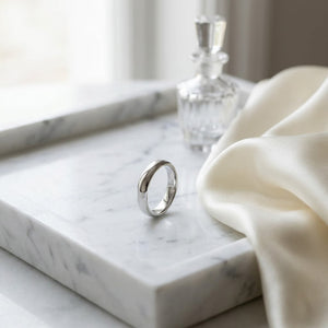 4mm High Dome Comfort-Fit Wedding Band in 18K White Gold, on marble vanity tray with silk