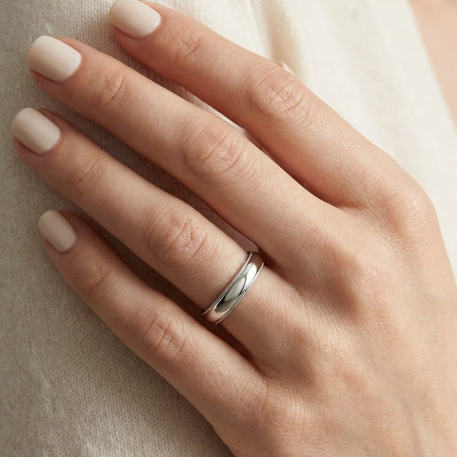 4mm Slightly Domed Milgrain Comfort-Fit Wedding Band in 18K White Gold, worn on hand, close-up