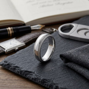 6mm Slightly Domed Double Milgrain Comfort-Fit Wedding Band in 18K White Gold, on walnut surface with pocket square
