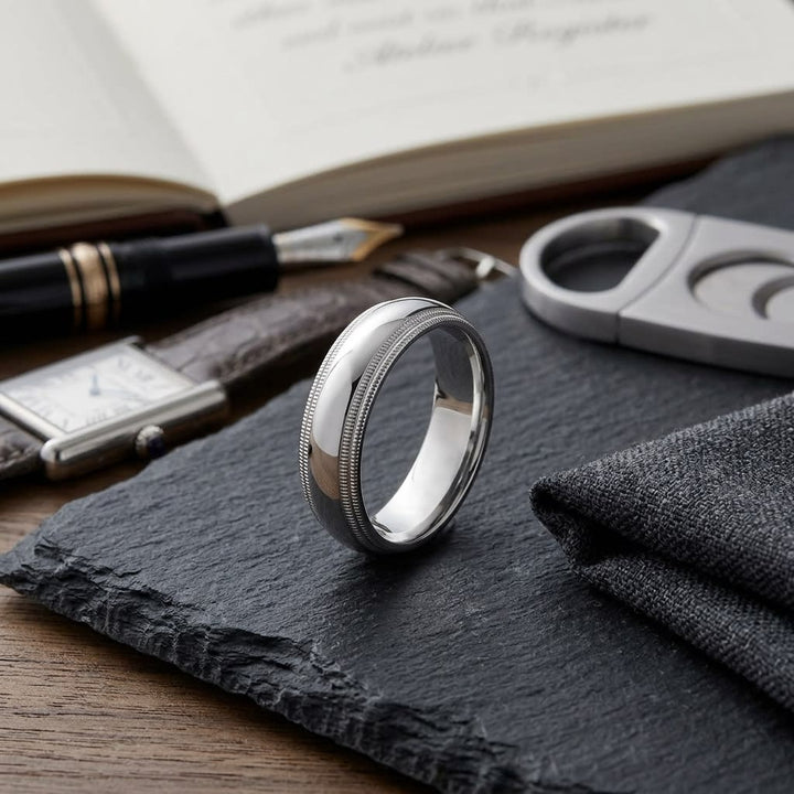 6mm Slightly Domed Double Milgrain Comfort-Fit Wedding Band in 18K White Gold, on walnut surface with pocket square