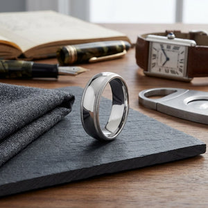 7mm Slightly Domed Double Milgrain Comfort-Fit Wedding Band in 18K White Gold, on walnut surface with pocket square