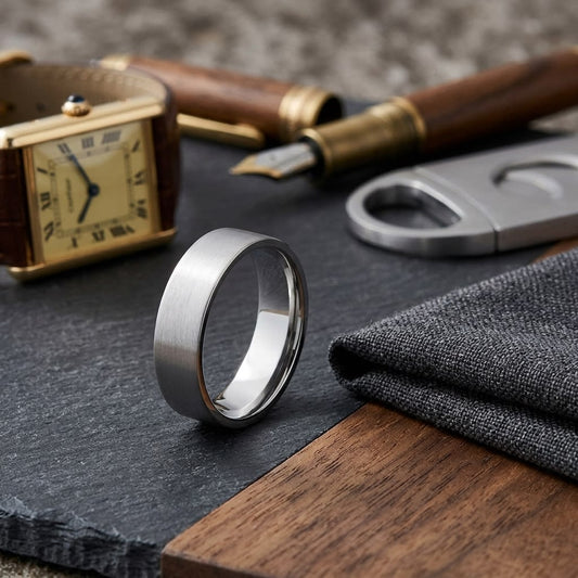 6mm Satin Finish Carved Wedding Band in 18K White Gold, on walnut surface with pocket square
