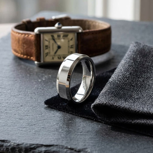 6mm High Polish Carved Wedding Band in 18K White Gold, on walnut surface with pocket square